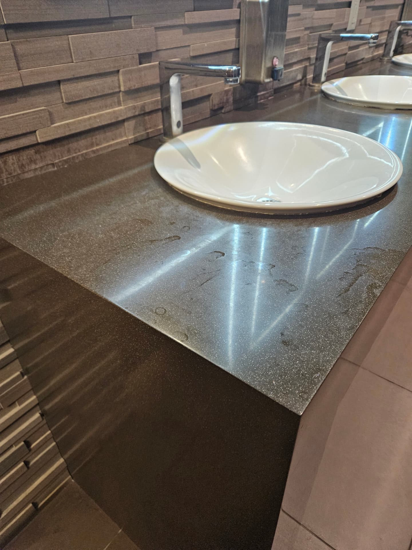 Polished restroom vanity counter and basin after VanFon detail cleaning